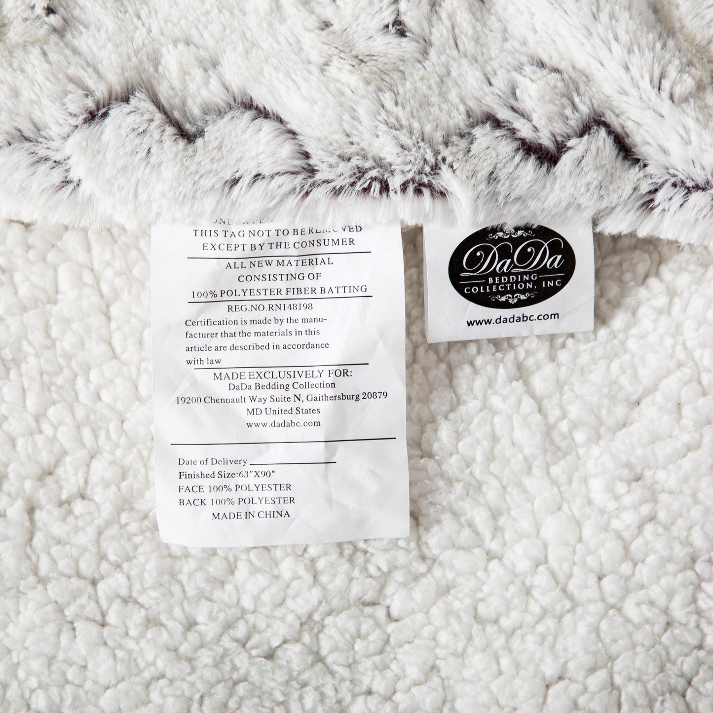 Product tag of milky white and purple faux fur throw blanket