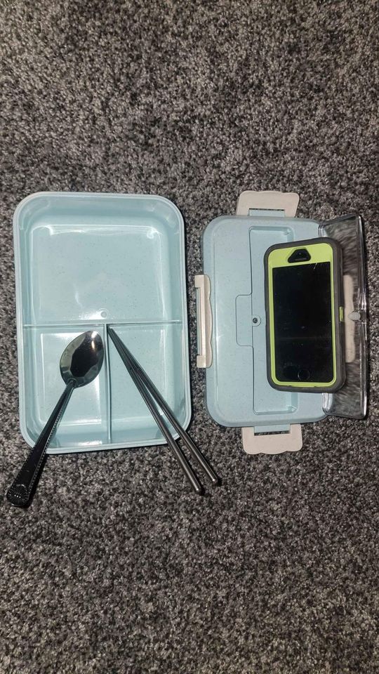 Microwave-safe bento lunch box with built-in phone stand and utensils
