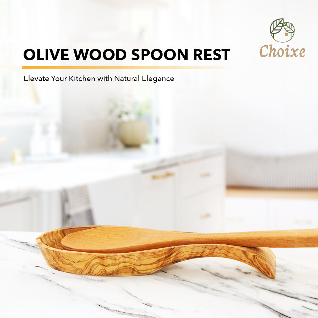 Olive wood spoon rest holding a cooking spoon on a kitchen counter