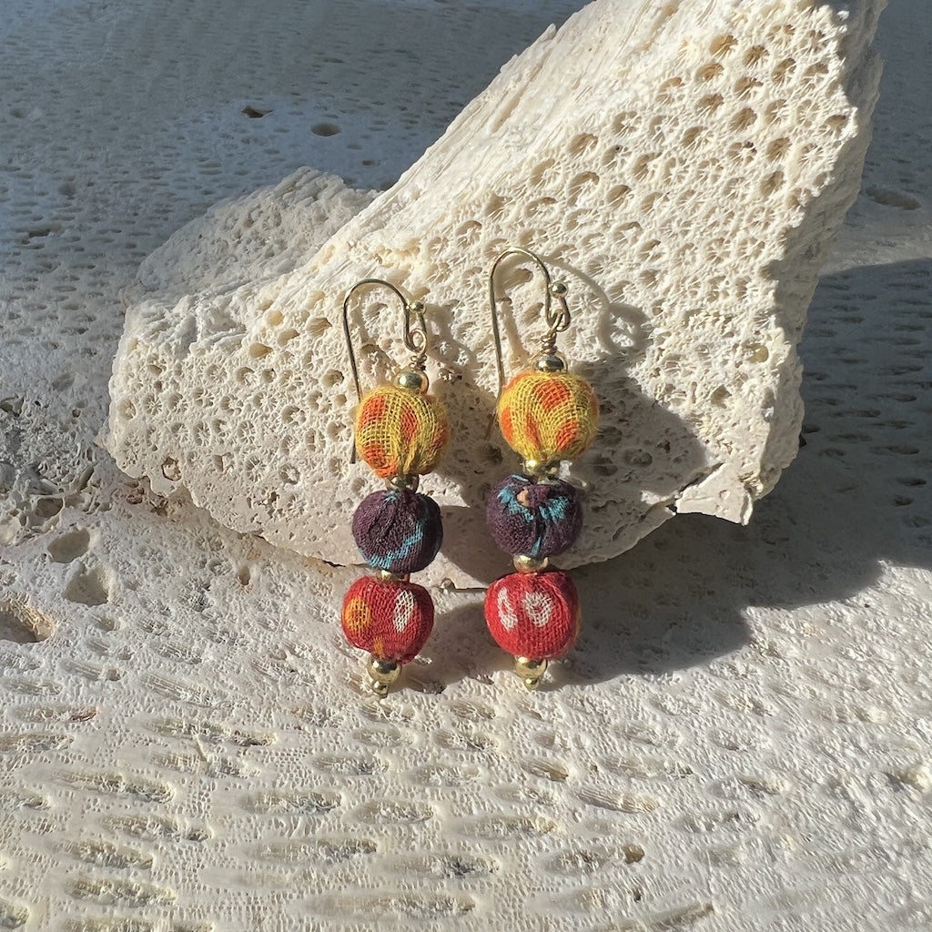 Handcrafted Kantha Sari Earrings displayed on neutral background, showing stacked fabric beads.