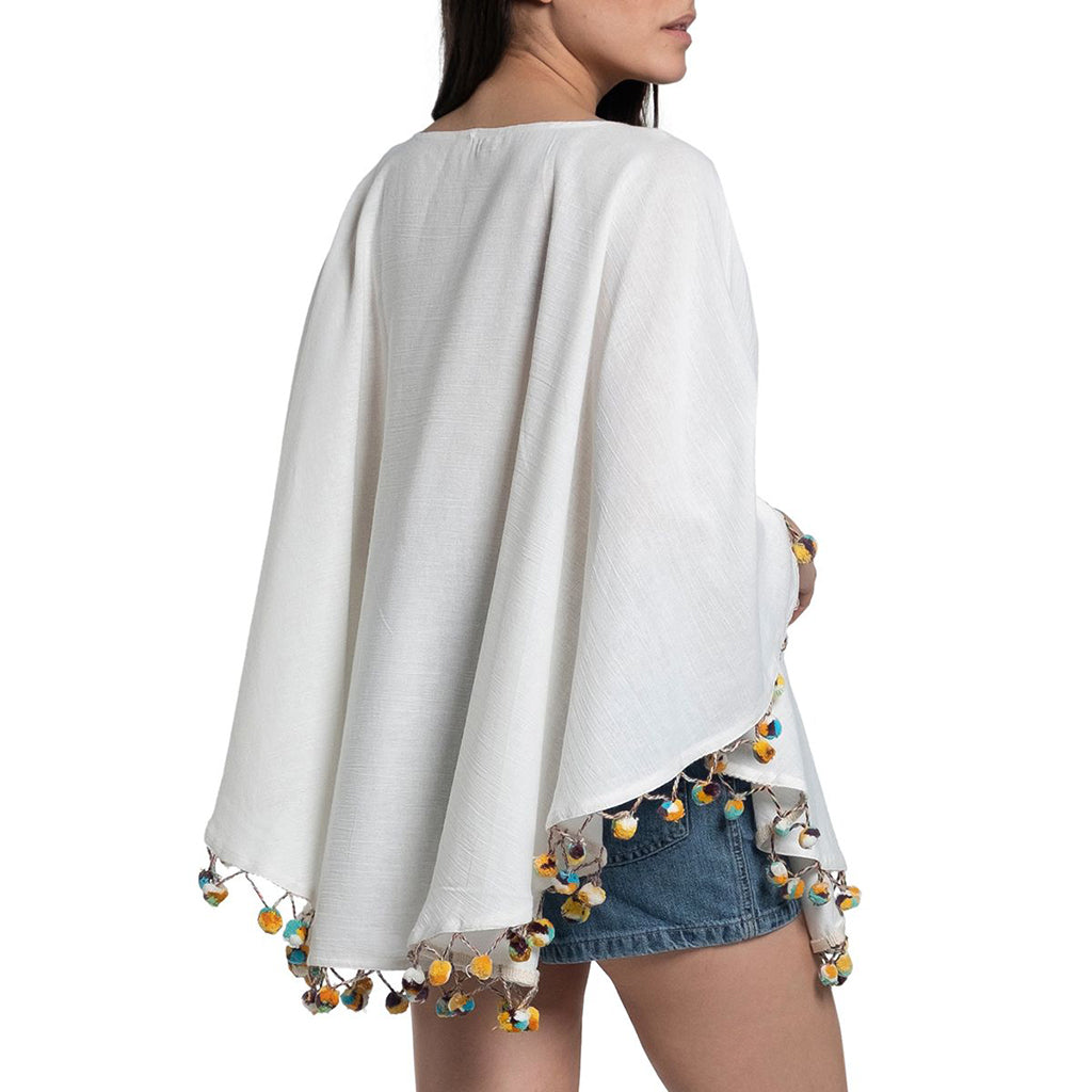 Side angle of Pom Pom Turkish Tunic highlighting breathable fabric and handwoven details.