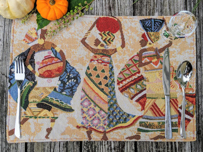 DaDa Bedding Kwanzaa Collection African Dreams placemats on dining table – colorful African women tapestry design in red and ivory tones.