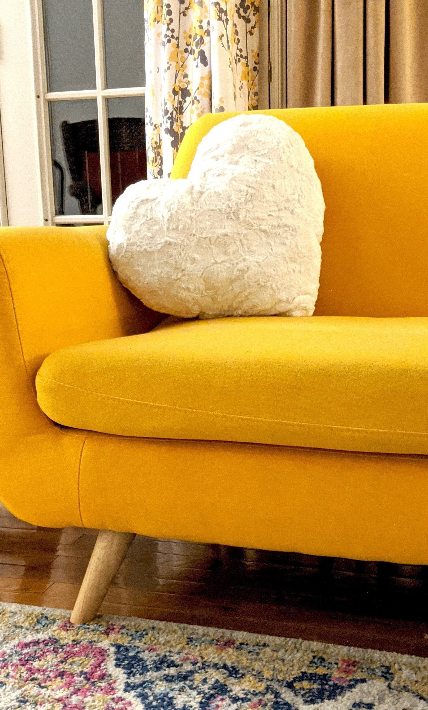 Heart pillow on sofa as cozy accent