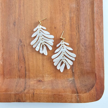 resort-style palm earrings seashell design