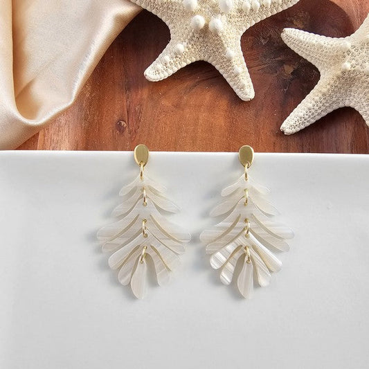 petite palm earrings seashell front view