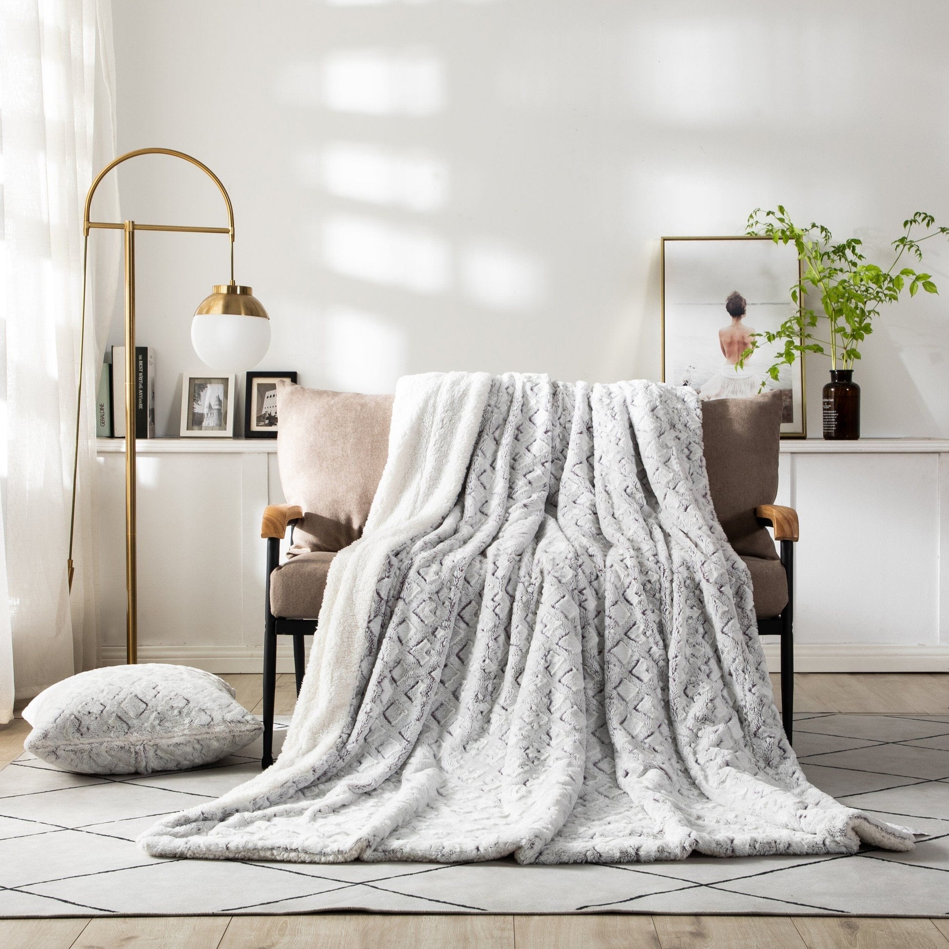 Milky white and purple faux fur throw blanket styled o accent chair as home decor.