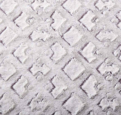 Close-up of plush faux fur fabric showing fluffy purple-and-white details
