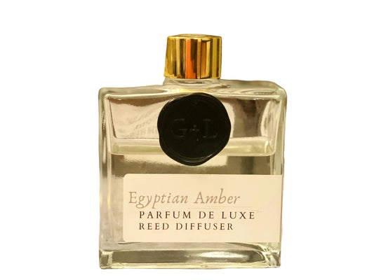 Egyptian Amber reed diffuser with gold cap and a white background.