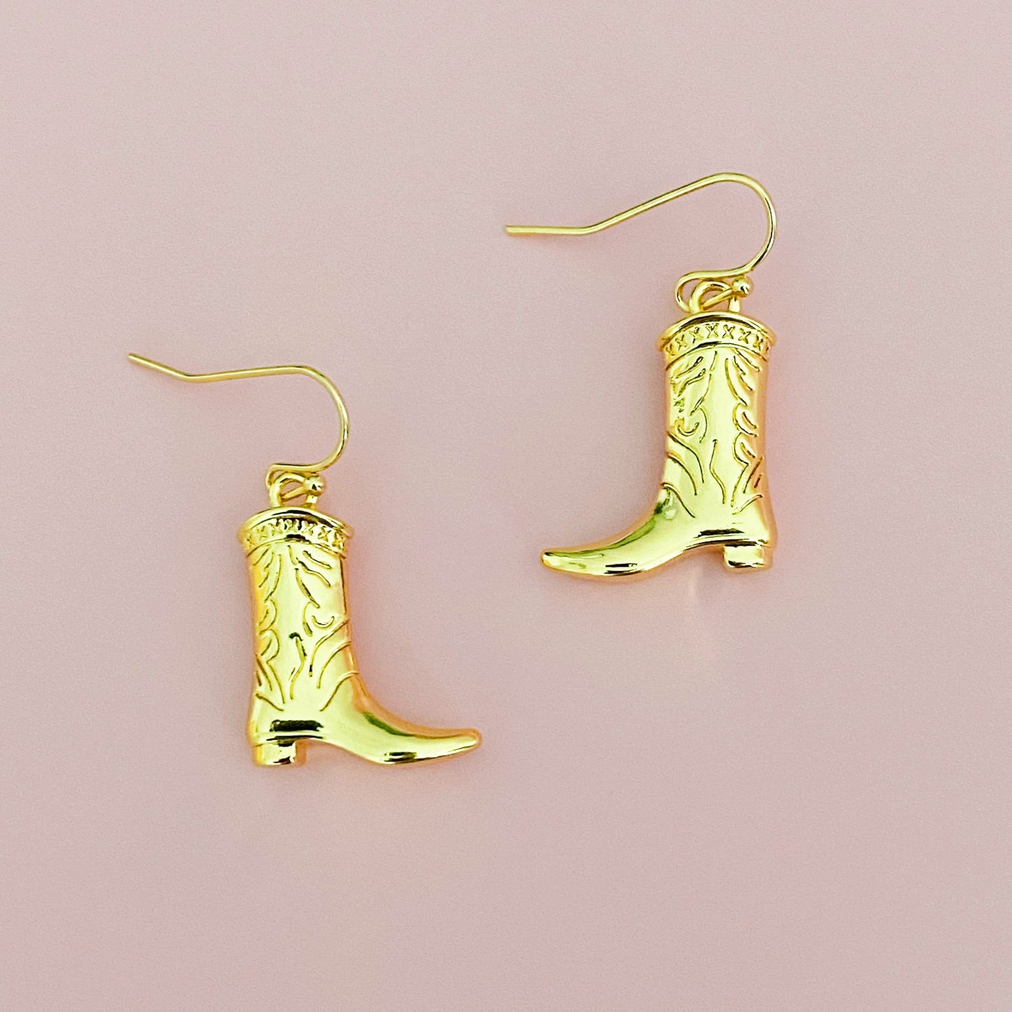 gold cowgirl bootie dangle earrings close up