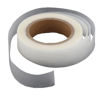 Roll of transparent fabric seam repair tape on a white background