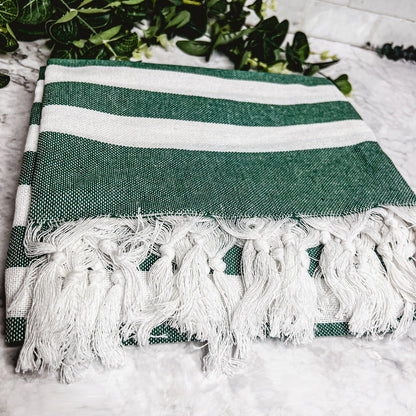 Green striped Bold Turkish towel showing hand-tied tassels