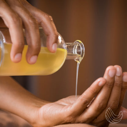 Dead Sea mineral oil held in hand for application