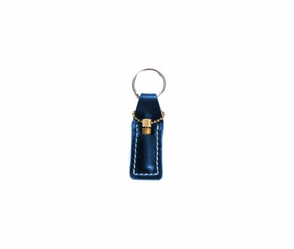 Krombee presents Blue leather keychain with gold accent on a white background