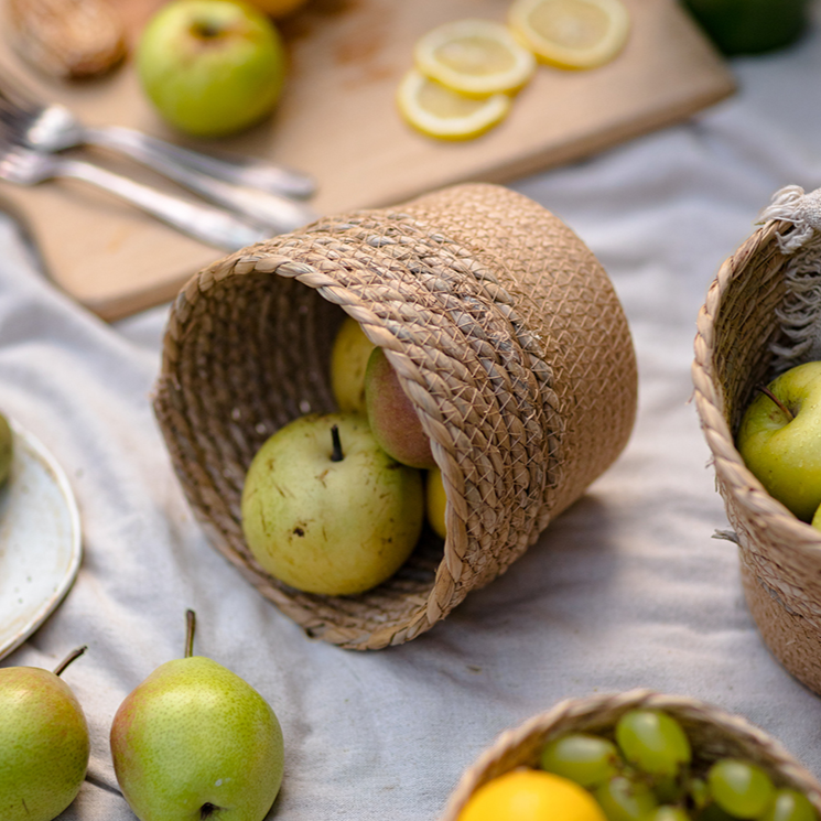 Small size straw desktop basket styled on a kitchen table with fruits