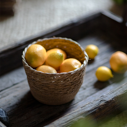 Medium natural straw basket displayed on a wooden desk