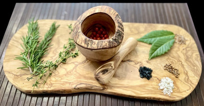 “Top-down view of olive wood mortar filled with fresh herbs, inspiring home cooks to create flavorful spice blends.”