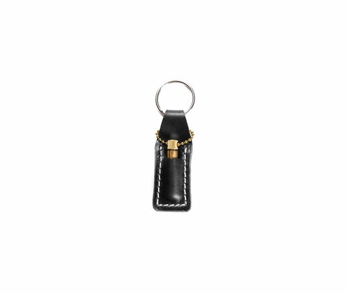 Krombee presents Black leather keychain with gold accent on a white background