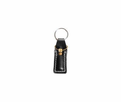 Krombee presents Black leather keychain with gold accent on a white background