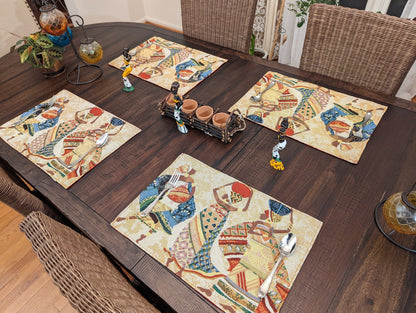 African Dreams tapestry placemat styled with dinnerware – vibrant Kwanzaa Collection dining table inspiration.