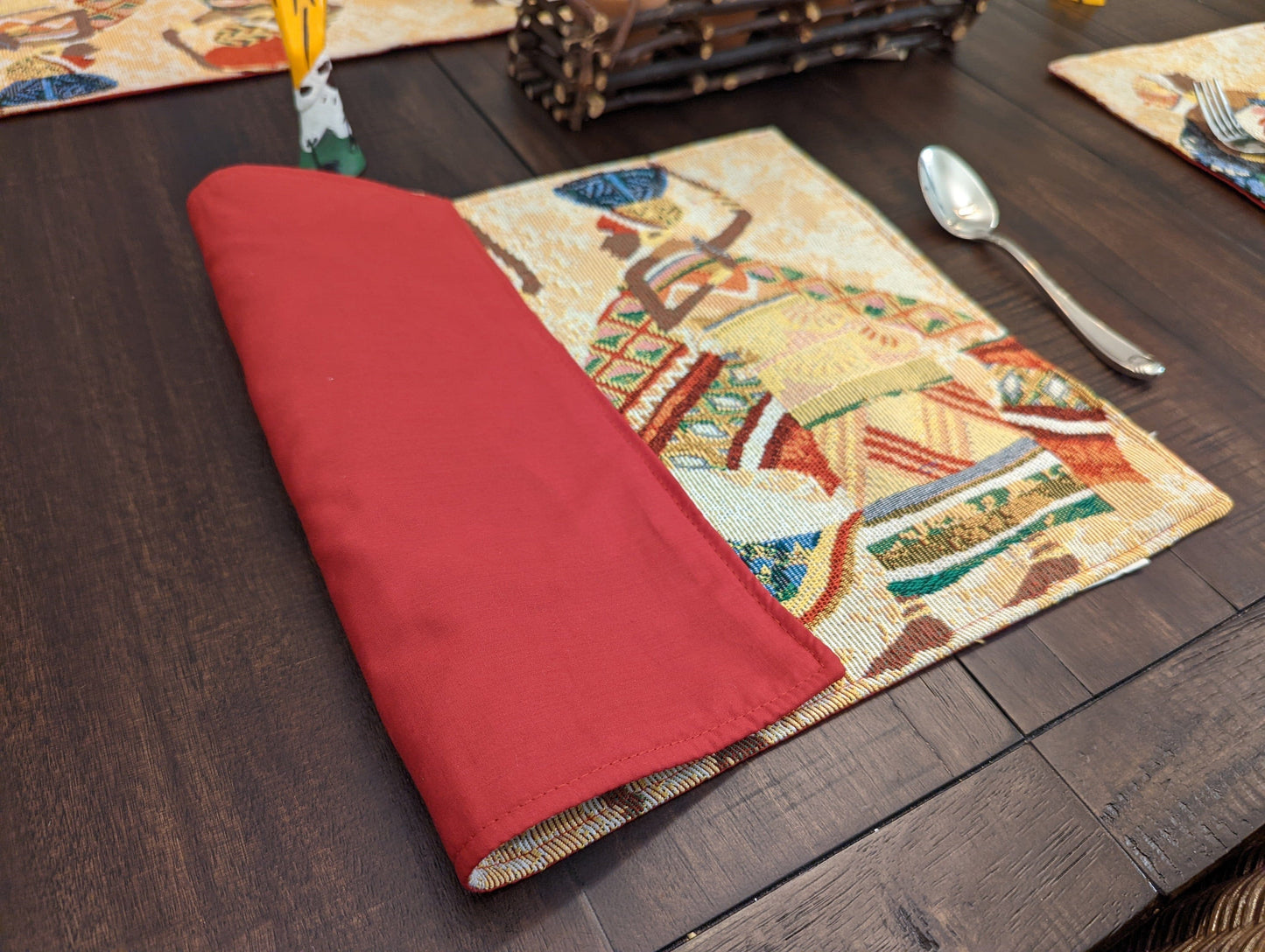 Back side of DaDa Bedding Kwanzaa Collection placemat – solid red fabric for reversible table styling.