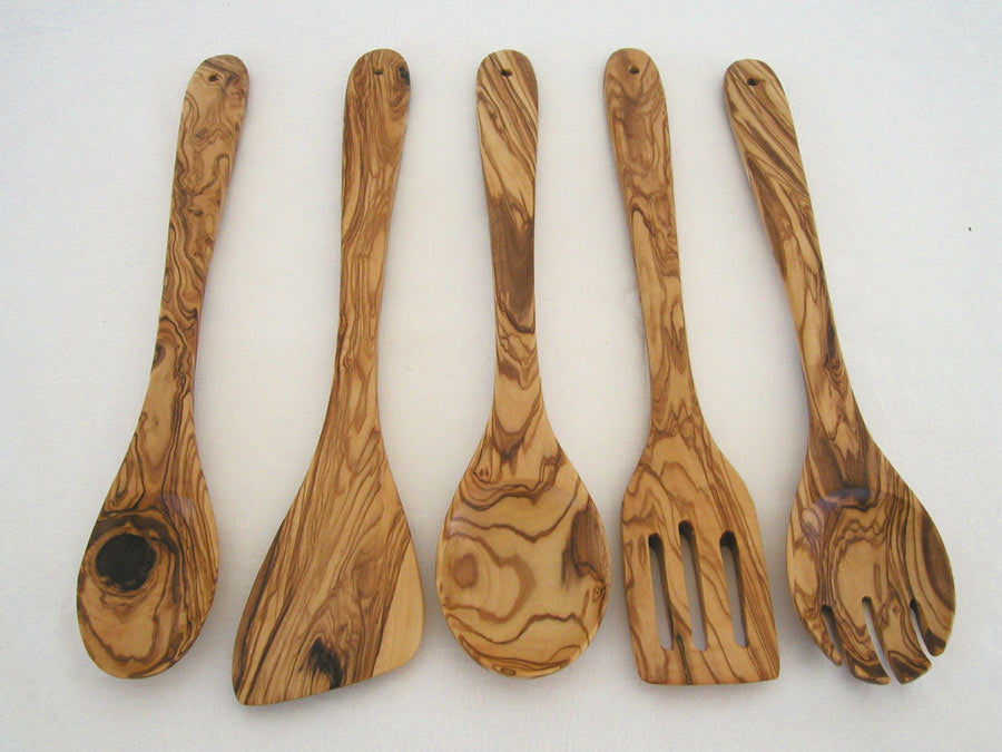 Handcrafted olive wood kitchen utensil set displayed together on a countertop