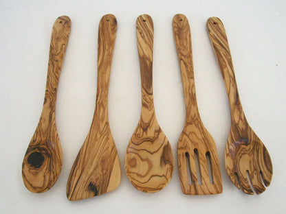Handcrafted olive wood kitchen utensil set displayed together on a countertop