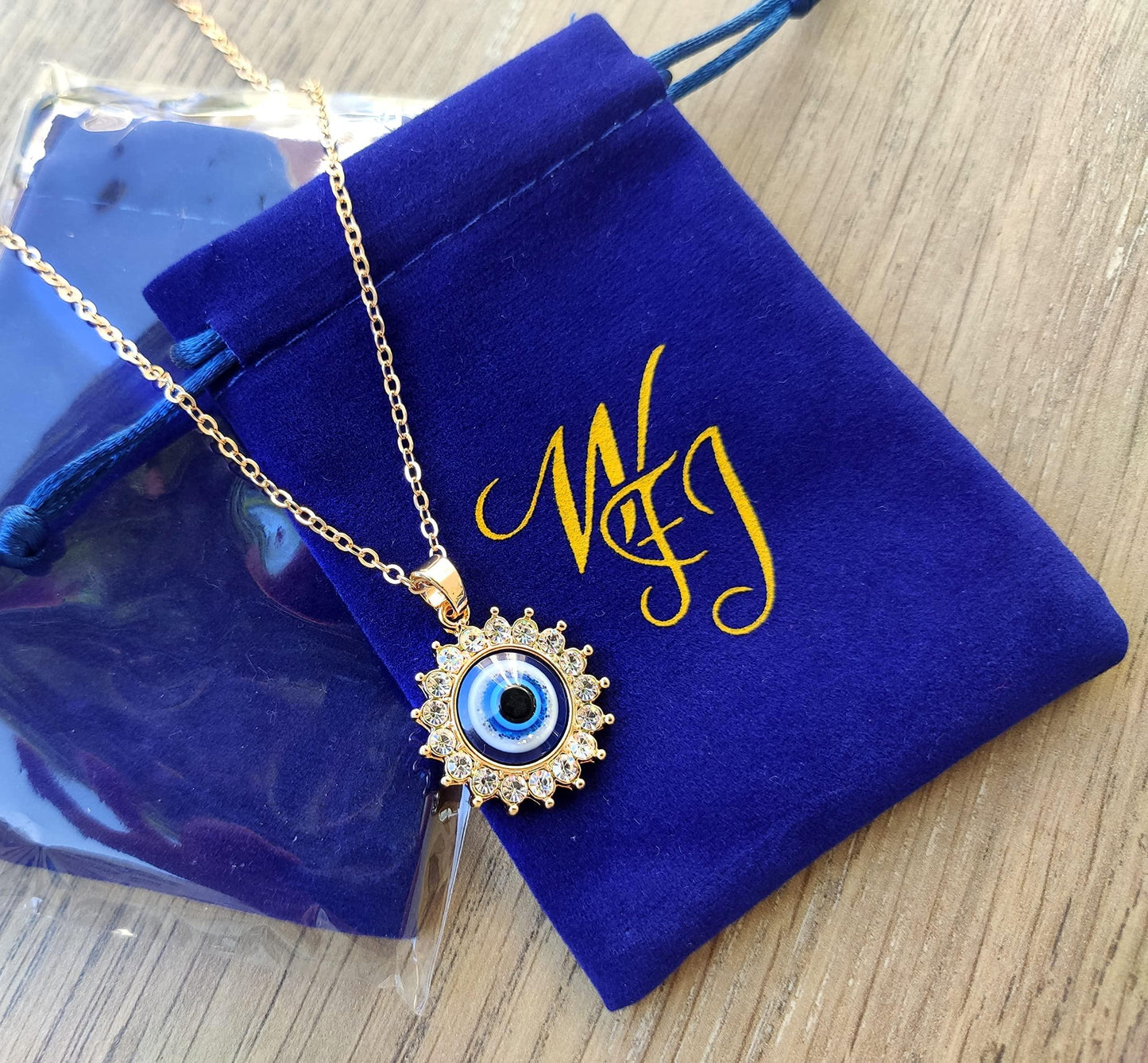 Adjustable gold chain necklace with protective eye pendant