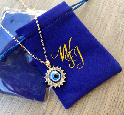 Adjustable gold chain necklace with protective eye pendant