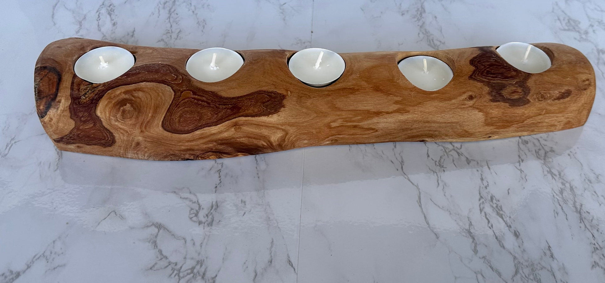 “Eco-friendly olive wood candle holder enhancing room ambiance with natural beauty.”

