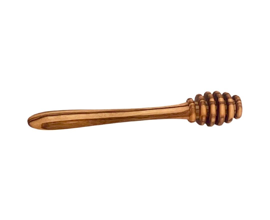 “Close-up of olive wood honey dipper demonstrating comfortable grip and elegant natural texture.”