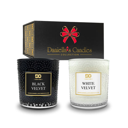 Two candles, one black and one white, with their packaging featuring 'Daniella's Candles' branding.
