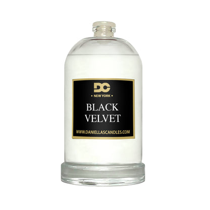 Candle in a glass jar labeled 'Black Velvet' by Daniella's Candles on a white background