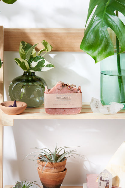 Krombee Pink soap bar on a wooden shelf with plants and decorative items