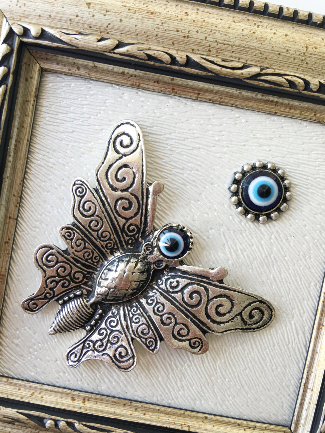 silver butterfly decor with protective eye