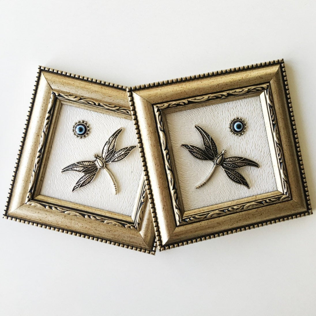 Minimalist framed wall décor with protective motif.