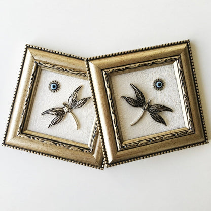 Minimalist framed wall décor with protective motif.