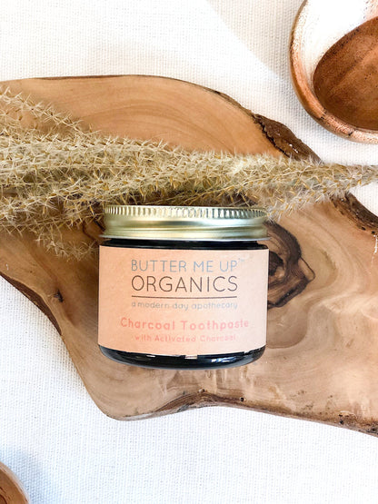 Organic activated charcoal toothpaste in 2oz glass jar with metal lid.