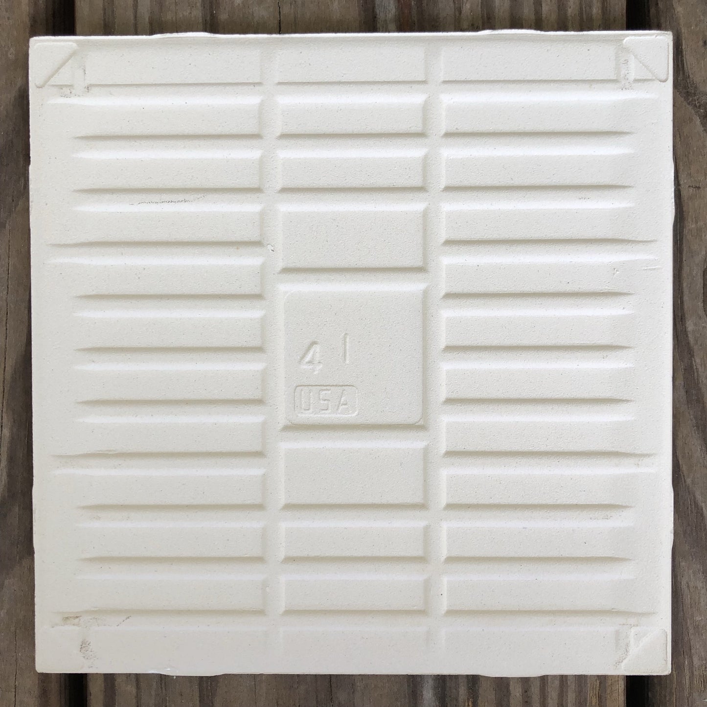 The backside of the handmade meadow tile with sparrow artwork