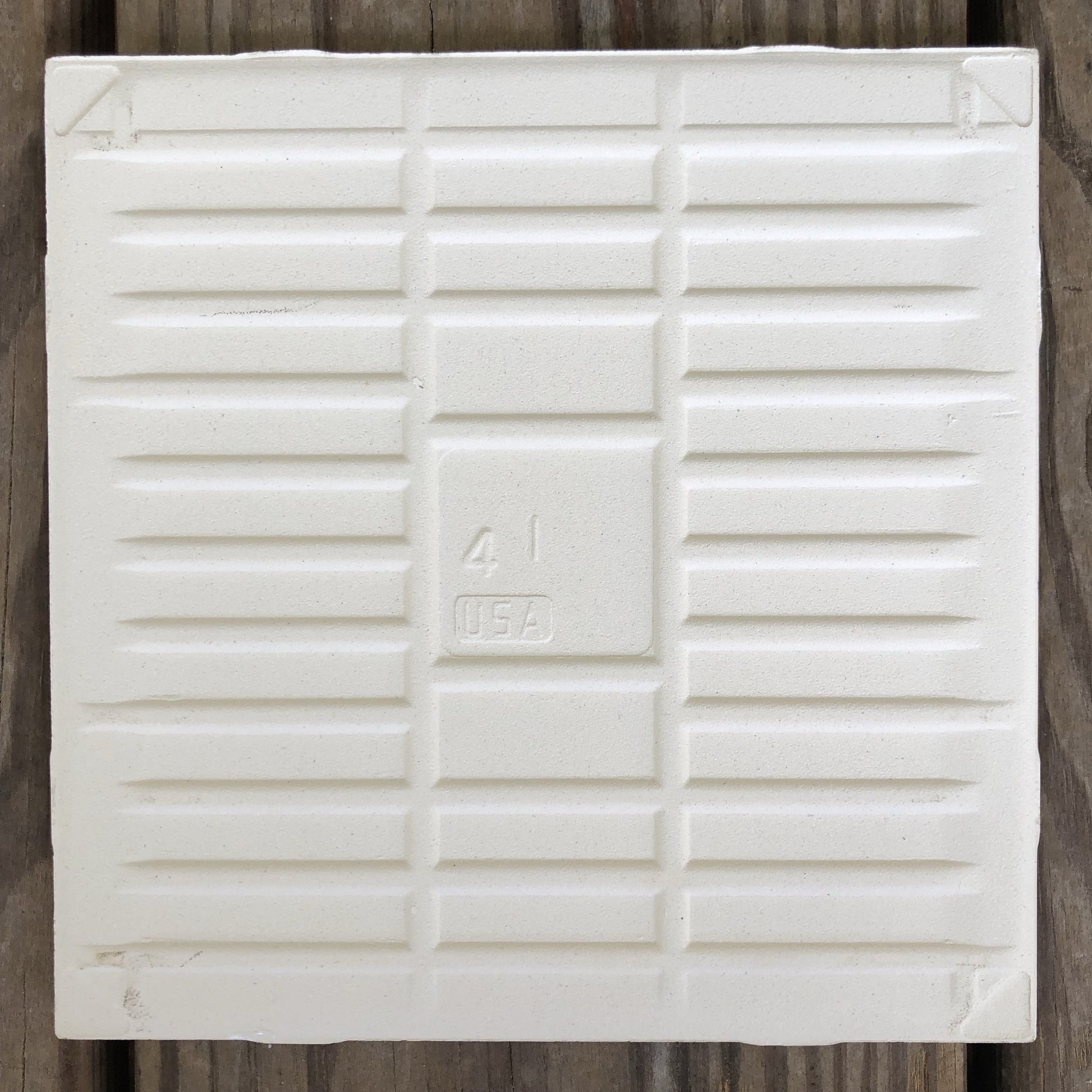 The backside of the handmade meadow tile with sparrow artwork