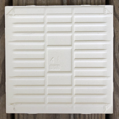 The backside of the handmade meadow tile with sparrow artwork