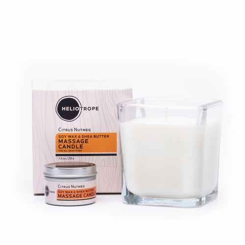Heliotrope Citrus Nutmeg massage candle with packaging on a white background