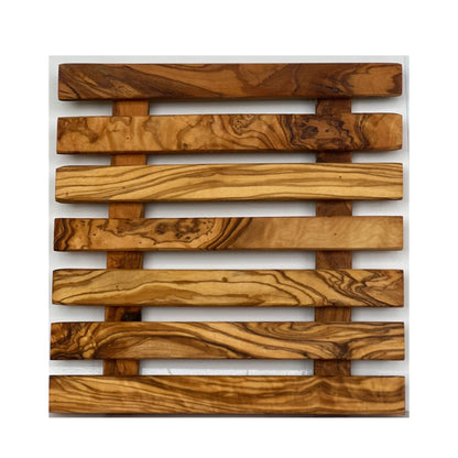 “Handcrafted olive wood pan coaster showcasing rich natural grain for elegant kitchen styling.”