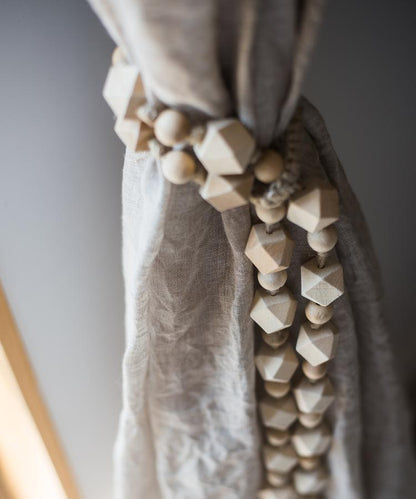 Curtain tied with natural rope and wood tieback