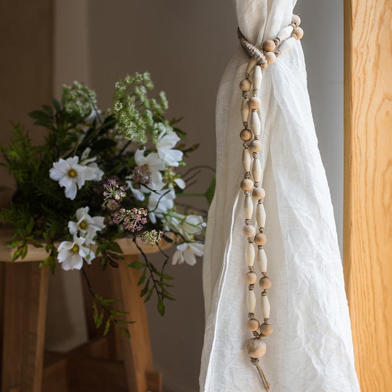 Curtain tied with natural rope and wood tieback