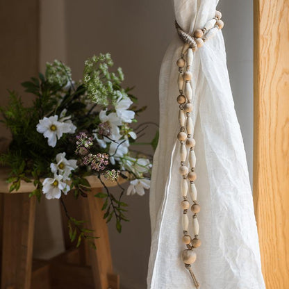 Curtain tied with natural rope and wood tieback