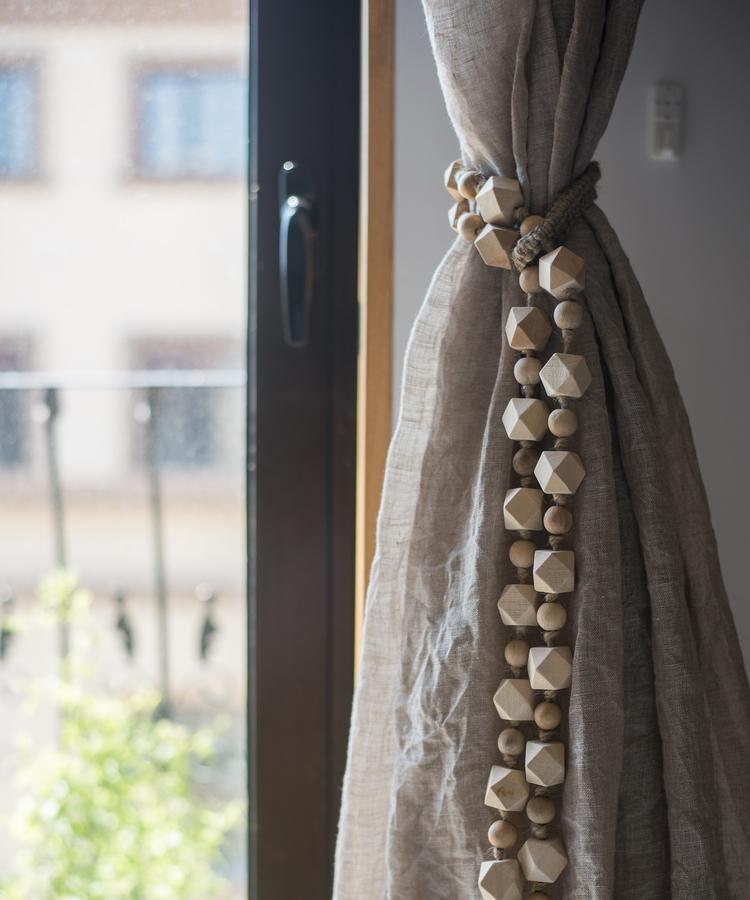 Curtain tied with natural rope and wood tieback