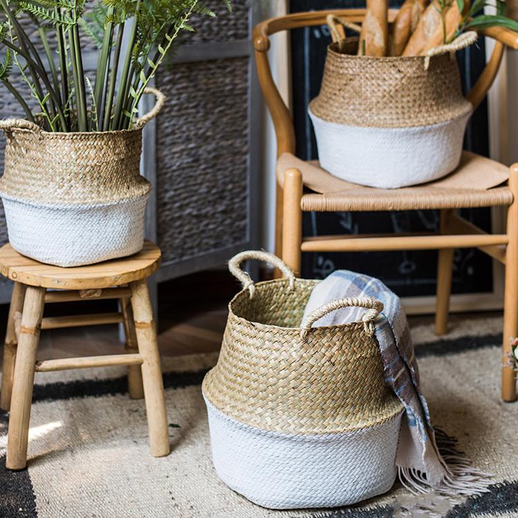 All 3 sizes of white color belly baskets used as a plant pot cover and blanket storage in a patio setting
