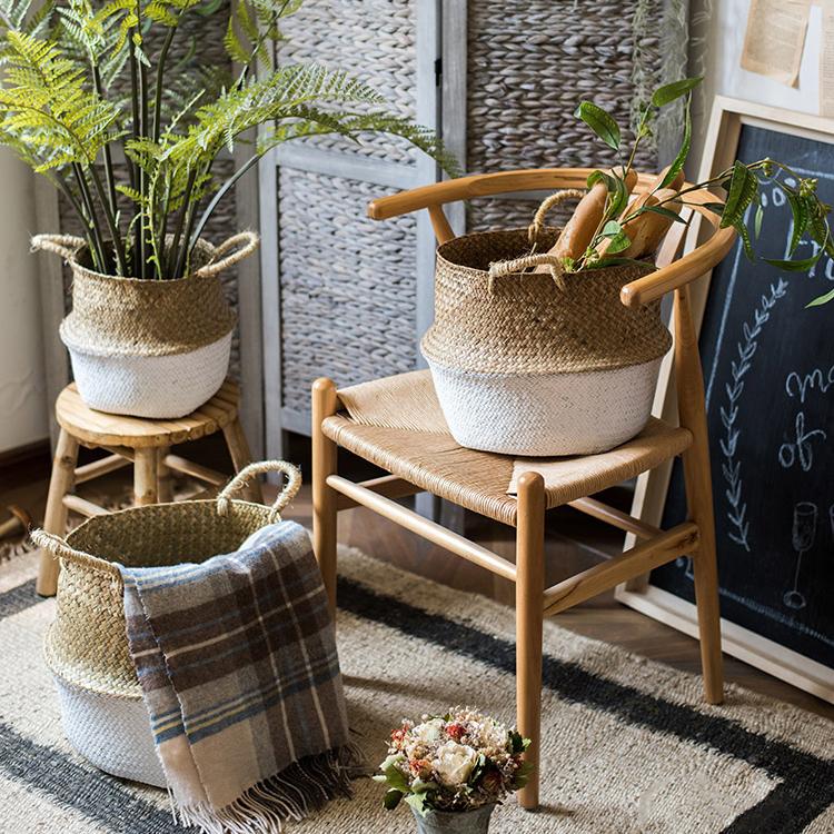 All 3 sizes of white color belly baskets used as a plant pot cover and blanket storage in a patio setting